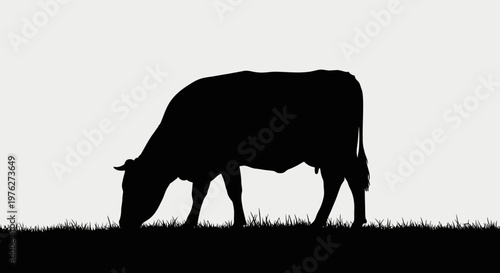 Silhouette of a grazing cow against a simple background for design elements