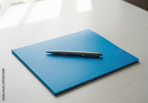 Blue medical folder pen on white desk under soft natural light, minimalist office scene with clear treatment feel