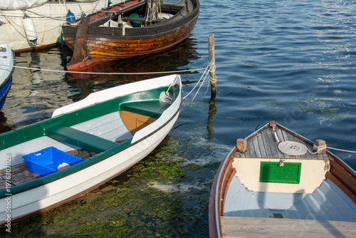 Rowboat anchored to the wooden post