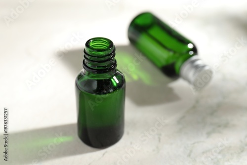 Bottles of cosmetic product on light table, closeup