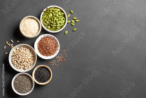 Fotografie Assortment of seeds in bowls for healthy eating