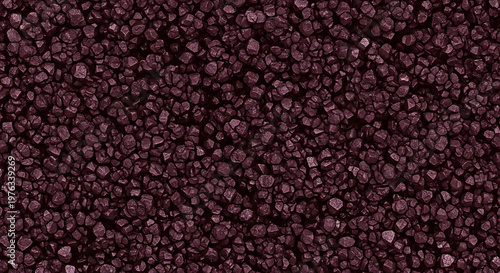Close up of dark reddish purple gravel or small stones creating a textured background