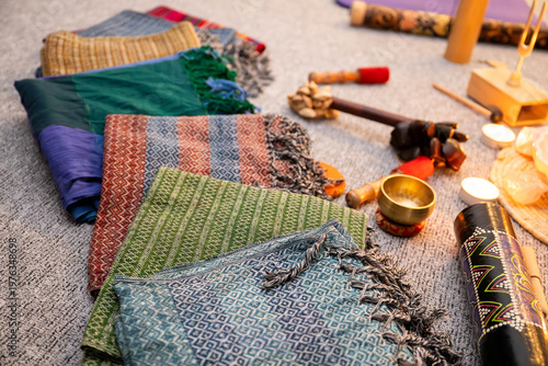 Rebozo massage and sound healing setup with Tibetan singing bowls, candles, yoga mats and traditional textiles, creating a calming wellness and holistic therapy atmosphere.
