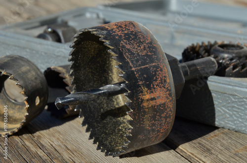 Close-up of a steel hole saw bit for wood on a neutral background.
