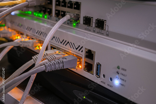 Obraz na płótnie Close-up of network equipment with ethernet cables connected to router and switch