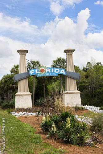 Welcome Sign for Florida Seen on a Sunny Day With Blue Sky and Green Plants Around the Entrance