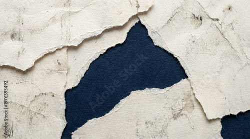 Foto Torn and peeling white paper revealing dark blue background texture