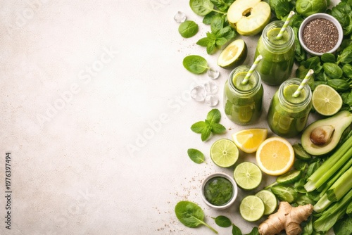 Green smoothies and fresh vegetables arranged as border on light background with copy space