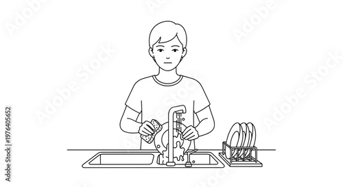 A focused young man is diligently washing dishes by hand at a kitchen sink, demonstrating a common household chore and responsibility.