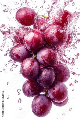 grape juice splash with whole grapes, isolated on white background