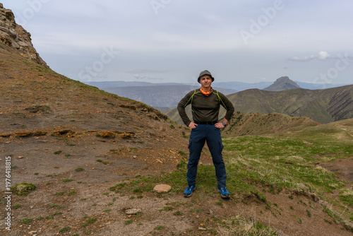 Man standing on a mountain with a scenic landscape. Dagestan Russia.