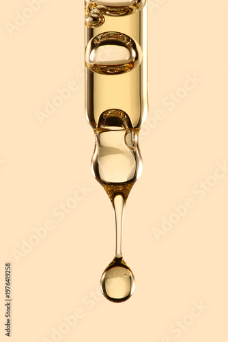 Golden Serum Drop from Glass Pipette – Macro Skincare Oil Texture