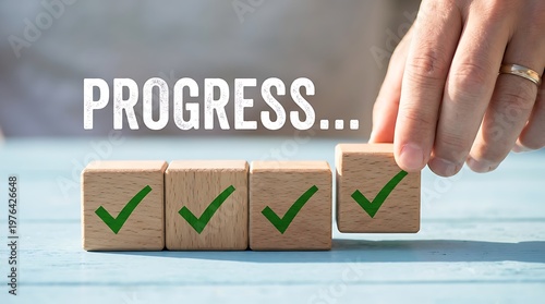 Progress concept showing hand placing wooden cube with green check mark symbol in row on blue table representing achievement success and milestone