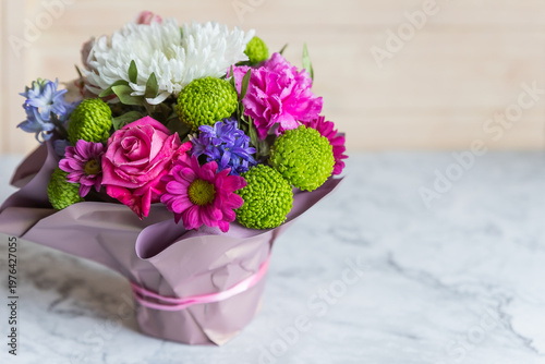 Absolutely gorgeous, multicoloured bouquet in a flower box on marble background.soft pastel floral composition for mother day celebration greeting and holiday. copy space