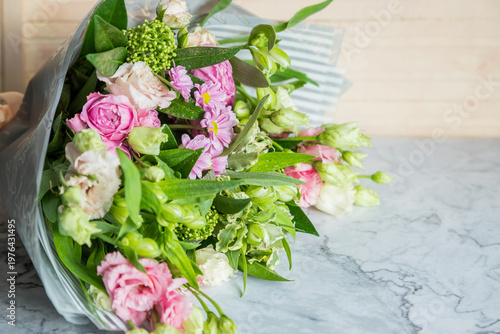 Celebrate special occasions with a colorful summer bouquet featuring fresh roses, eustoma blooms, creating an elegant and fragrant floral arrangement. love concept. copy space