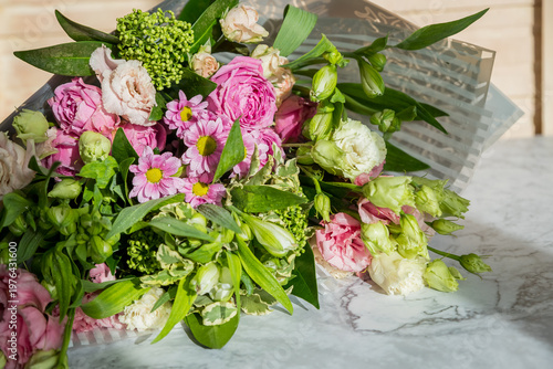 Celebrate special occasions with a colorful summer bouquet featuring fresh roses, eustoma blooms, creating an elegant and fragrant floral arrangement. love concept. copy space