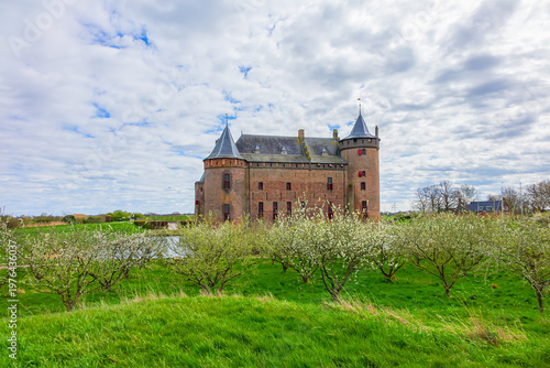 The medieval Castle Muiden (Muiderslot). Muiderslot was commissioned by Count Floris and completed in 1285. View of Muiden Castle from its gardens. Muiden, The Netherlands.