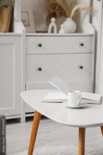 Cup of coffee with book on ...