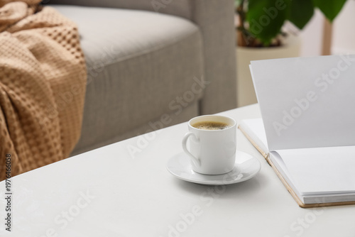 Cup of coffee with book on ...