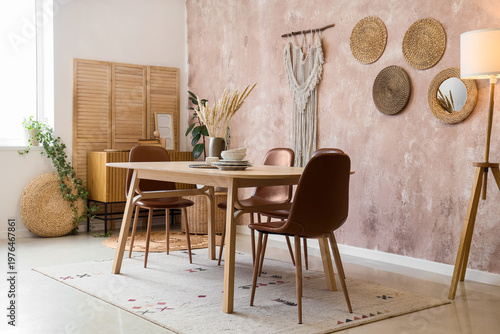 Interior of stylish dining room with table and folding screen