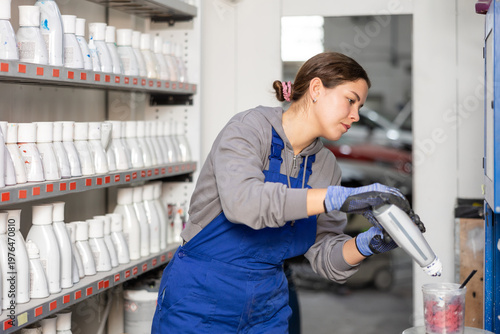 Photos Girl colorist selects paint color by mixing different paint colors for subsequen