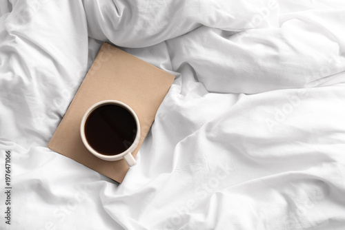 Cup of coffee and book on w...