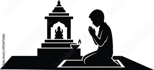 Person praying at a Hindu altar with a lit oil lamp and deity statue Keywords: person, silhouette