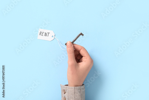 Hand holding old house key ...