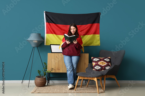 Young woman reading book in...