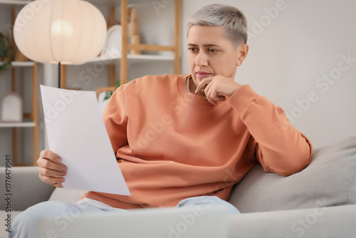 Thoughtful mature woman in ...