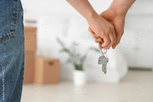 Young couple with keys from...