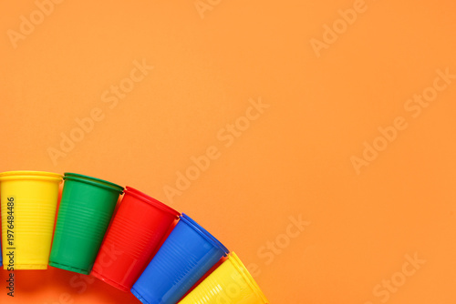 Colorful plastic cups on or...