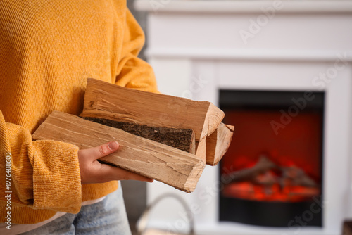 Young woman with firewood a...