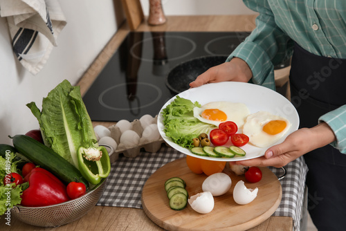 Woman with plate of vegetab...