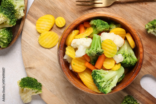 Bowl with stewed mixed vegetables on light background