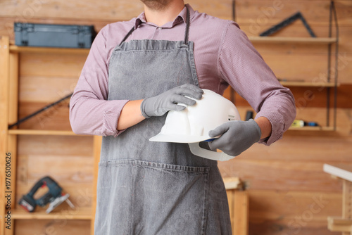 Man holding hardhat in work...