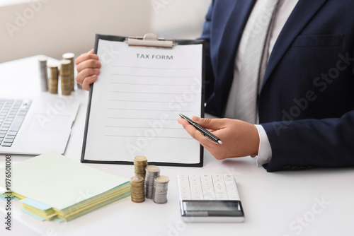 Businessman with tax form a...