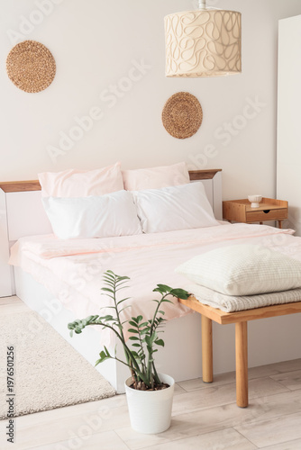 Bed with stylish pink beddi...