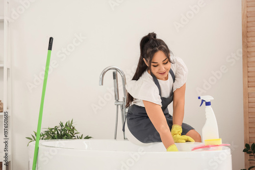 Female janitor cleaning bat...
