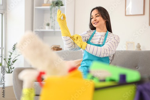 Female janitor putting on r...