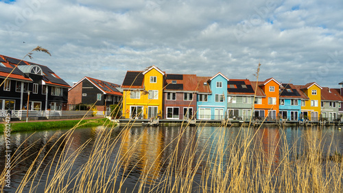 Lovely and colorful buildings reflecting on harbour water at twilight, Reitdiephaven, Groningen, Netherlands