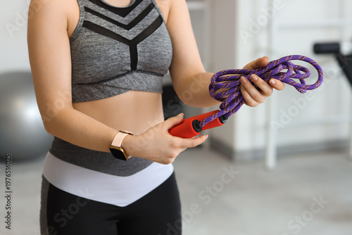 Sporty woman with skipping ...