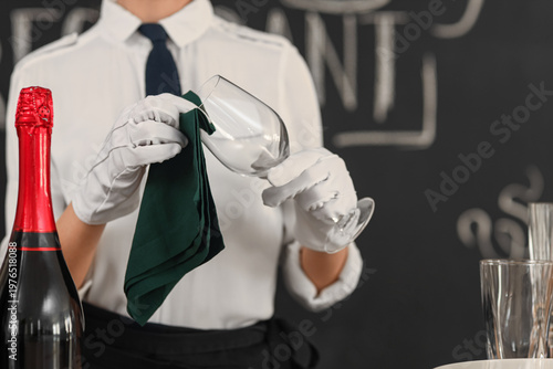 Young waitress cleaning gla...