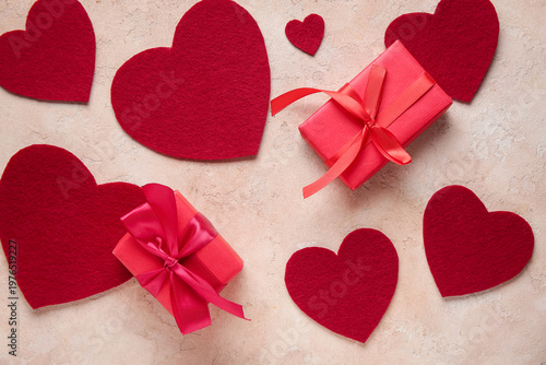 Gift boxes with heart shaped decor on beige grunge background. Valentine's Day celebration