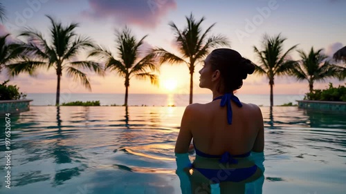 Latina woman relaxing in infinity swimming pool at tropical beach sunset