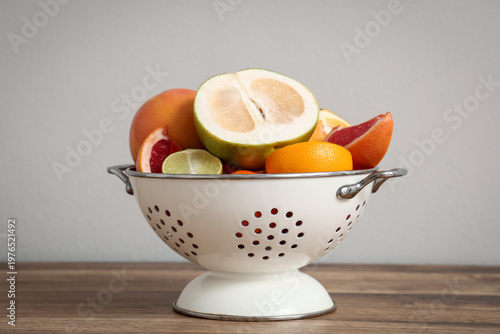 Colander with citrus fruits...