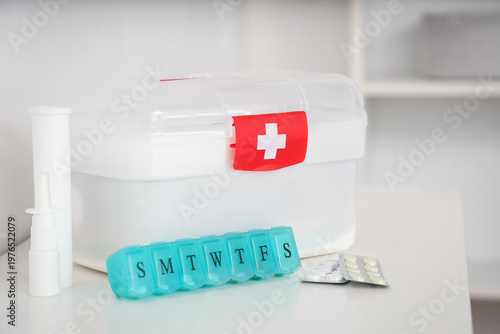 First aid kit with pills on...