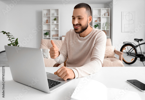 Young man with laptop video...