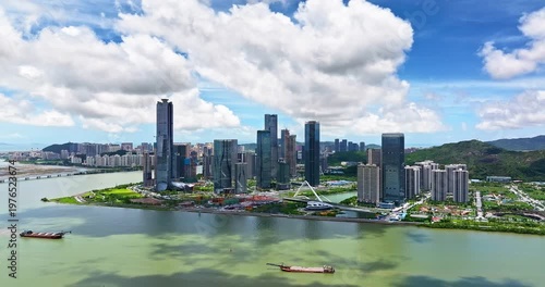 Drone view of modern financial district skyscrapers and city skyline by the river, Zhuhai, China.