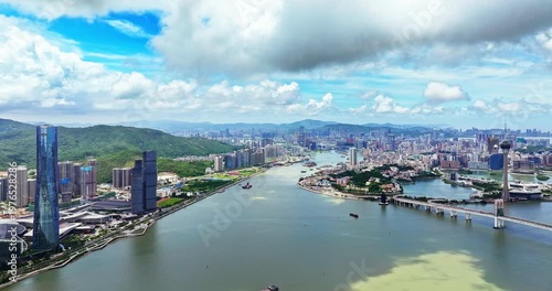 Drone view of Zhuhai city skyline and Macau Tower across the water, China.